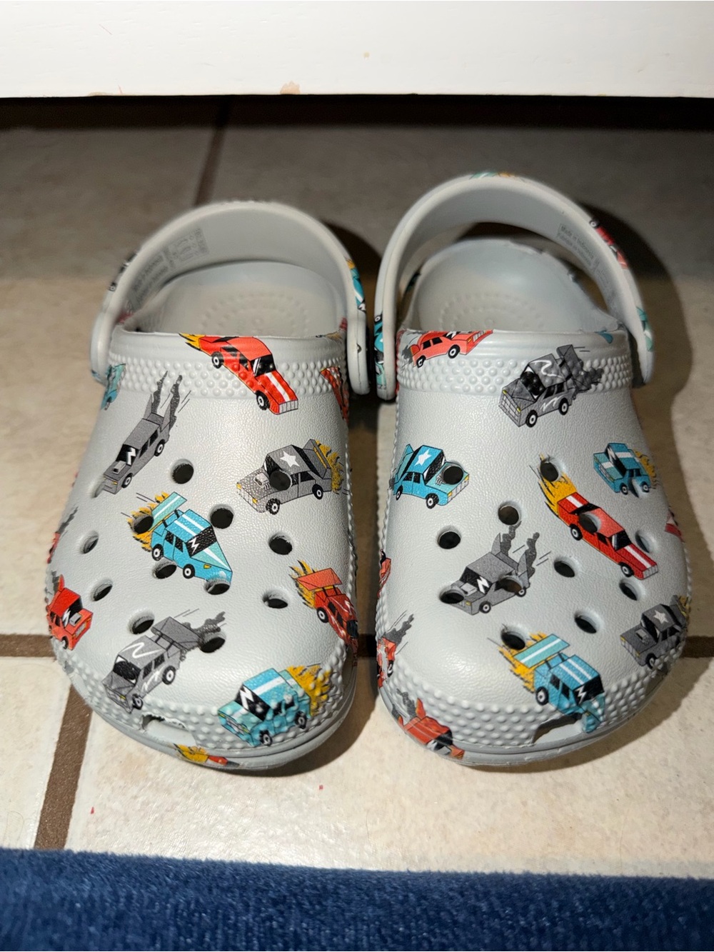 CROCS Kids Light Gray Clog with Red, Blue, Yellow and Gray Car Print
